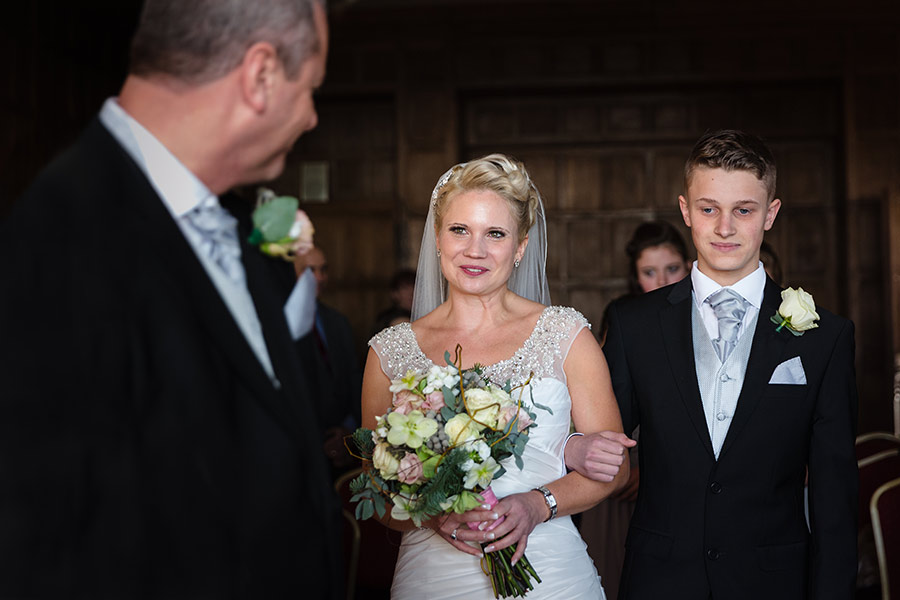 Bride walks down the isle of at The West Wing at Lympne Castle