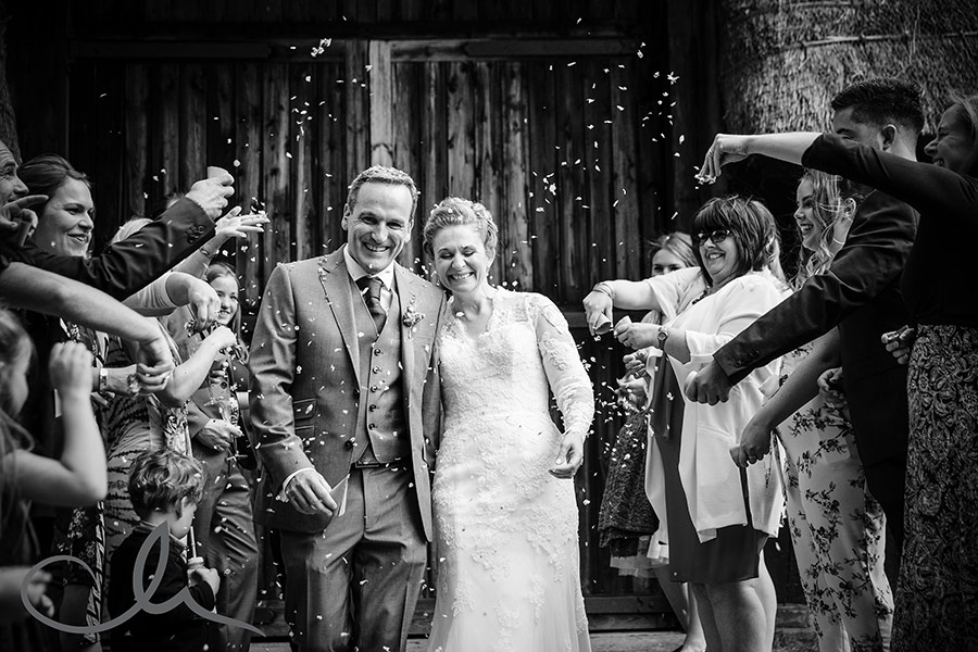 newlyweds have confetti showered over them at their Kent Village Wedding