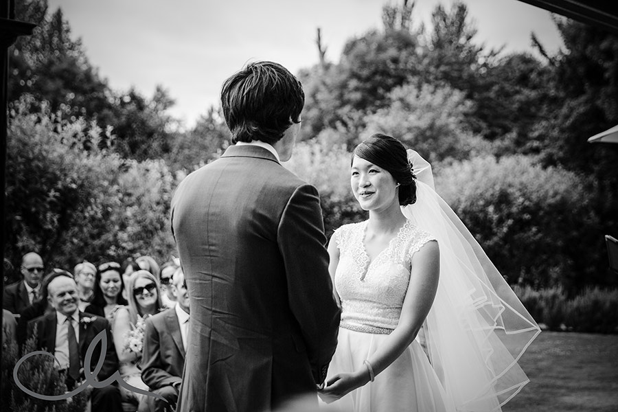 The bride and groom exchange their marriage vowes at the Secret Garden Kent