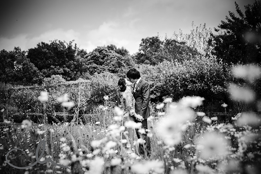 newlywed couple have a romantic portrait shot in the wild flower garden at The Secret Garden Kent 