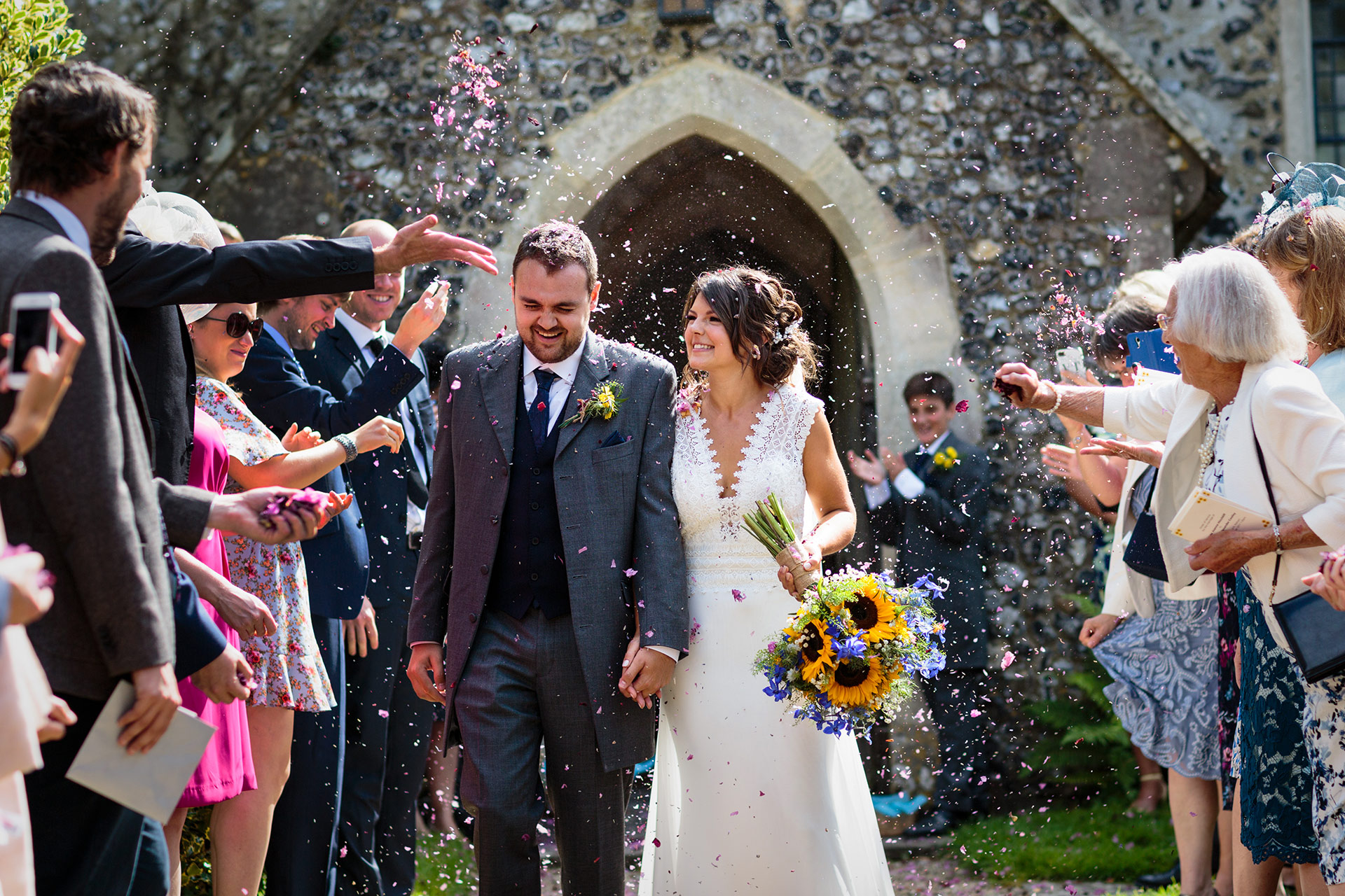 couple are just married and are showered with confetti at Petham Church Kent