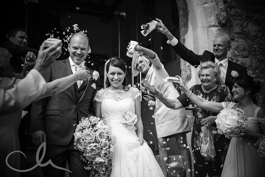 newly wed couple are showered with confetti at Hythe Church