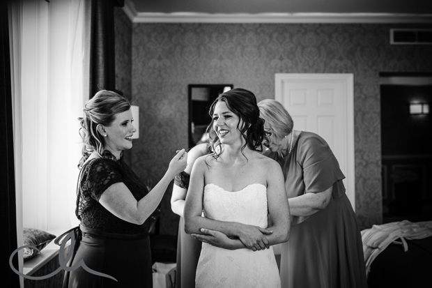 Bride to be has dress put on with the help of her bridesmaids at The Hythe Imperial Hotel