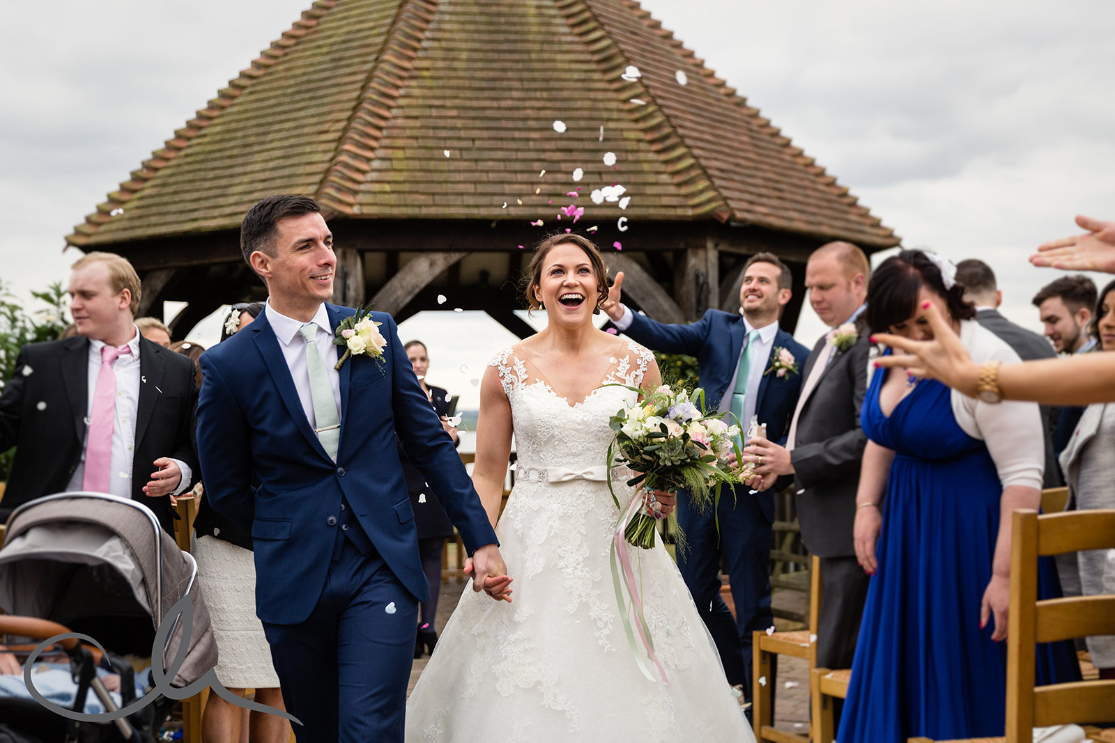 newlywed couple are showered with confetti at Ferry House Inn