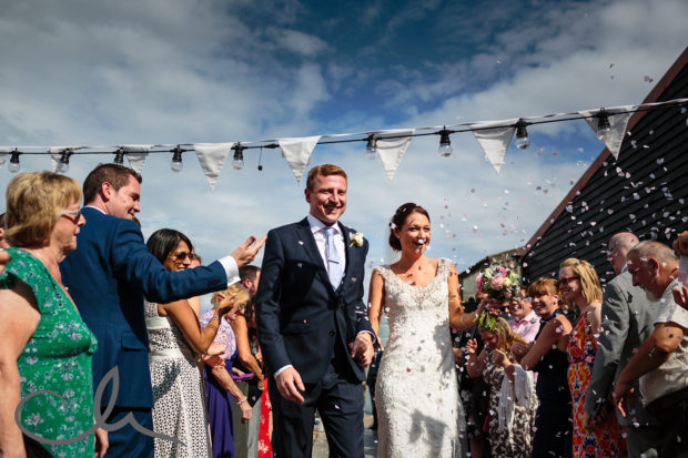 newlyweds are showered with confetti at East Quay wedding venue kent