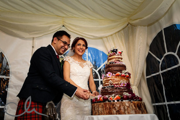 Newlyweds cut their cake at Lympne Castle