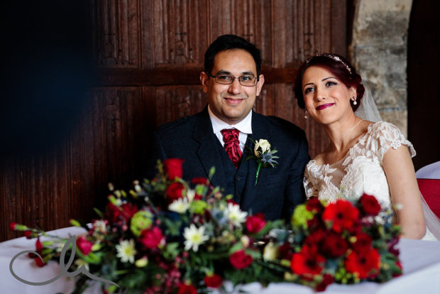 newlyweds sign the register at their Lympne Castle Wedding