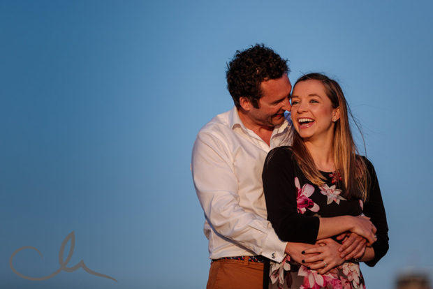 the engaged couple have fun on their engagement shoot in Jersey CI