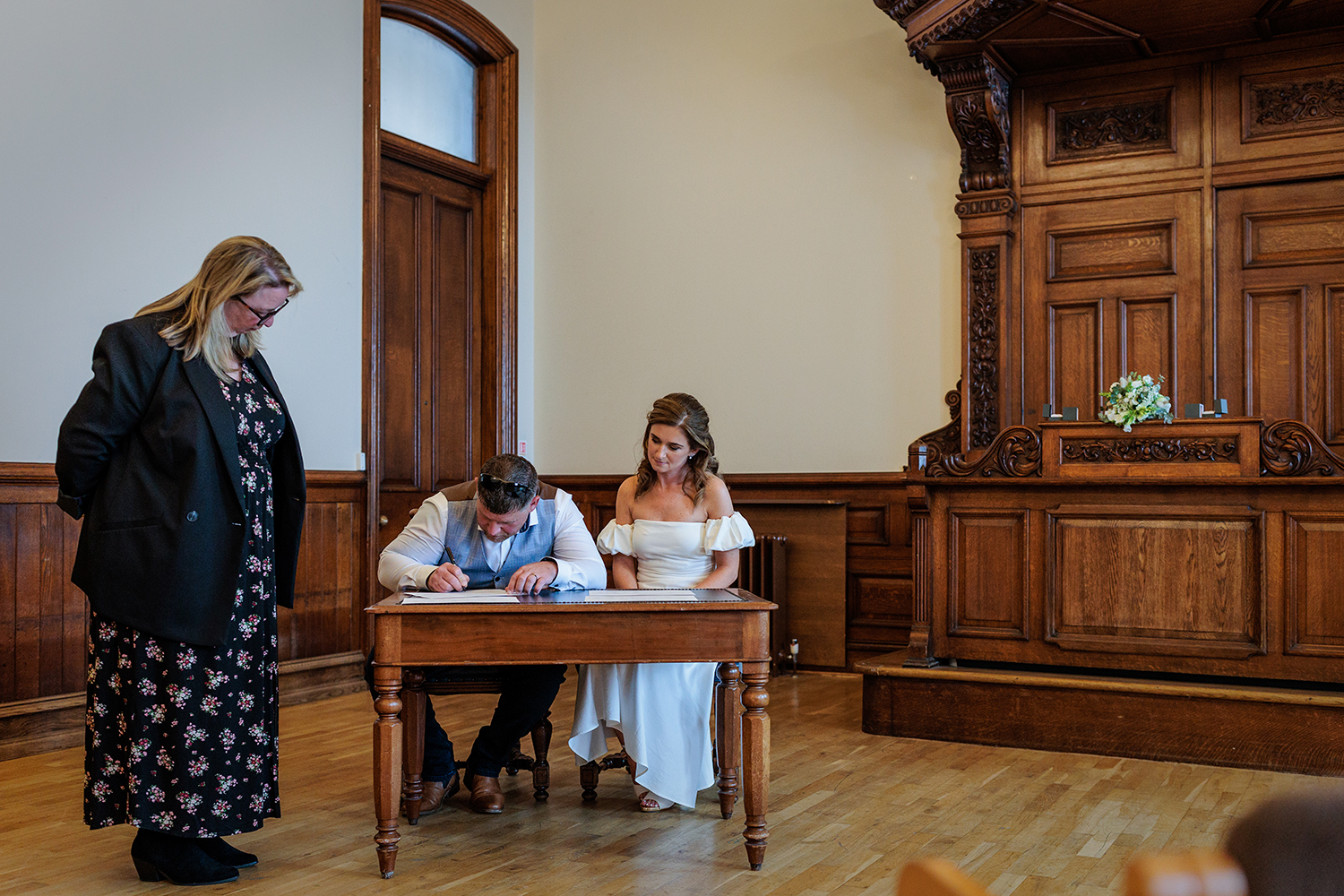 Elope to Jersey - the couple sign the legal marriage certificate after their wedding at The Old Magistrate's Court, Jersey, CI