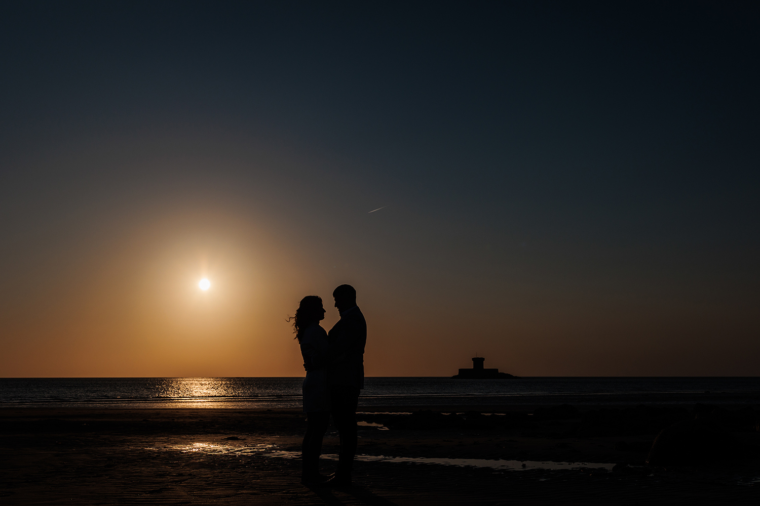 silhouette of newlywed couple at La Pulente after their elopement wedding in Jersey