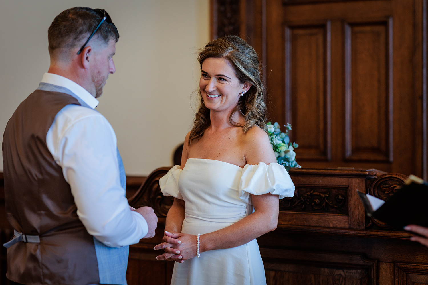 The bride smiles at her husband to be as they take their vows at their elopement wedding in Jersey
