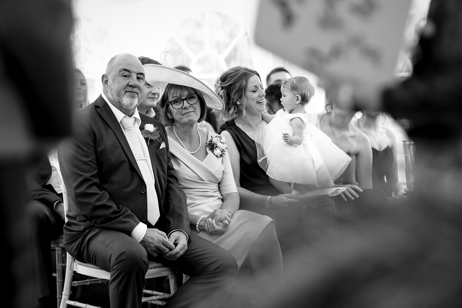 The grooms mother and father look lovingly on as their son marries his sweetheart at La Mare Wine Estate Jersey, CI