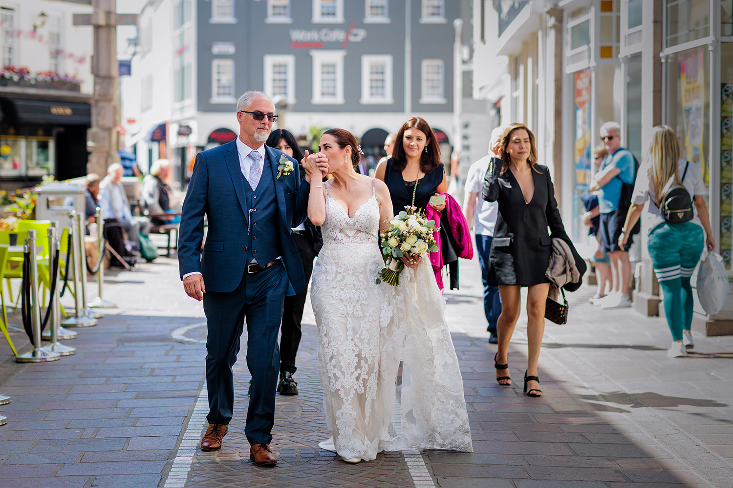 Steve and Berenice look joyful as they have become husband and wife after their wedding ceremony at The Old Magistrates Court, Jersey CI. They walk hand in hand through the streets of St Helier and Bernice kisses Steve's hand